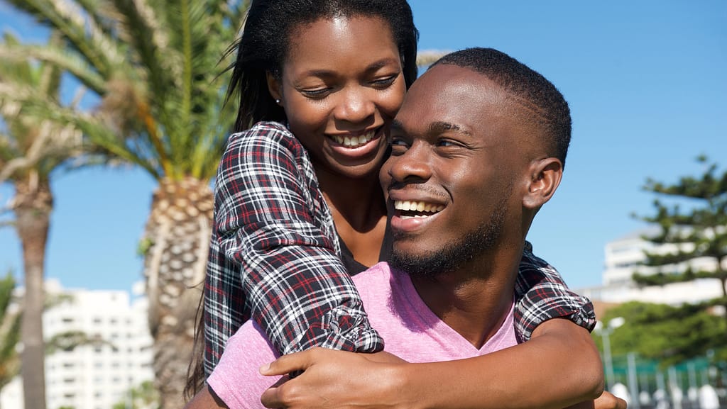 A couple laughing together, representing playful connection.