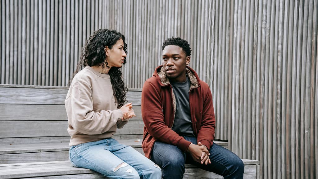 A couple having a deep conversation, showcasing open communication.